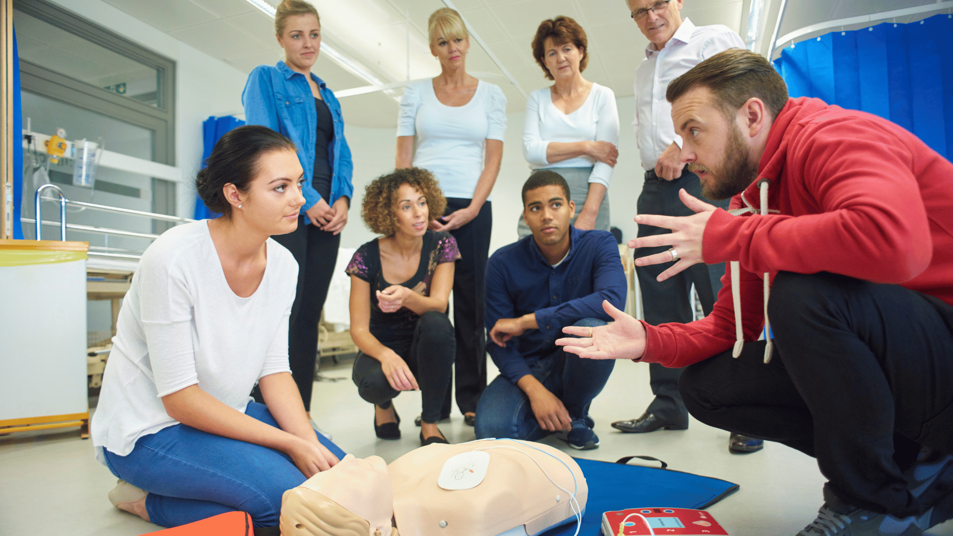 Tutor teaching emergency first aid at work